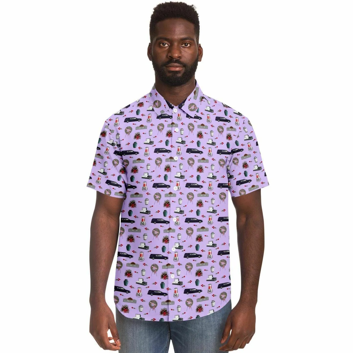 model wearing button up shirt in light purple with pattern of purple hearses, grey and silver caskets or coffins, white urns and funeral flower wreath with pink roses, and an embalming machine
