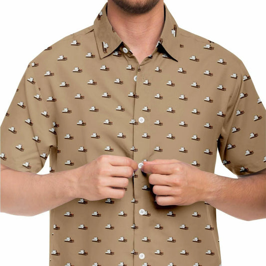 Close up frontal view of model wearing a light brown button up shirt with a dark brown steel casket pattern on it. The pattern contains small and subtle coffins.