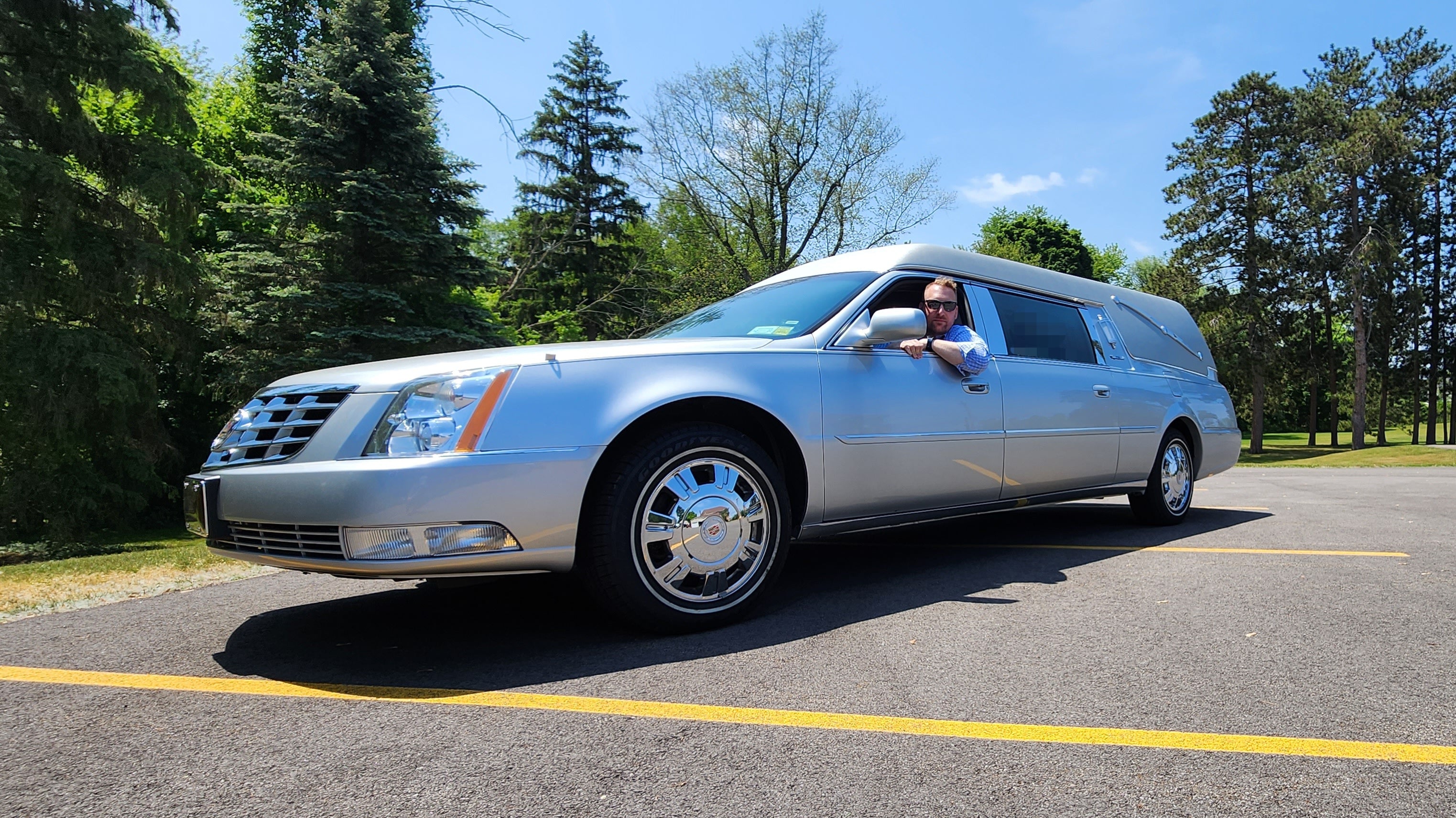 Brandon the Funeral DIrector in a 2011 Cadillac S&S Silver Hearse