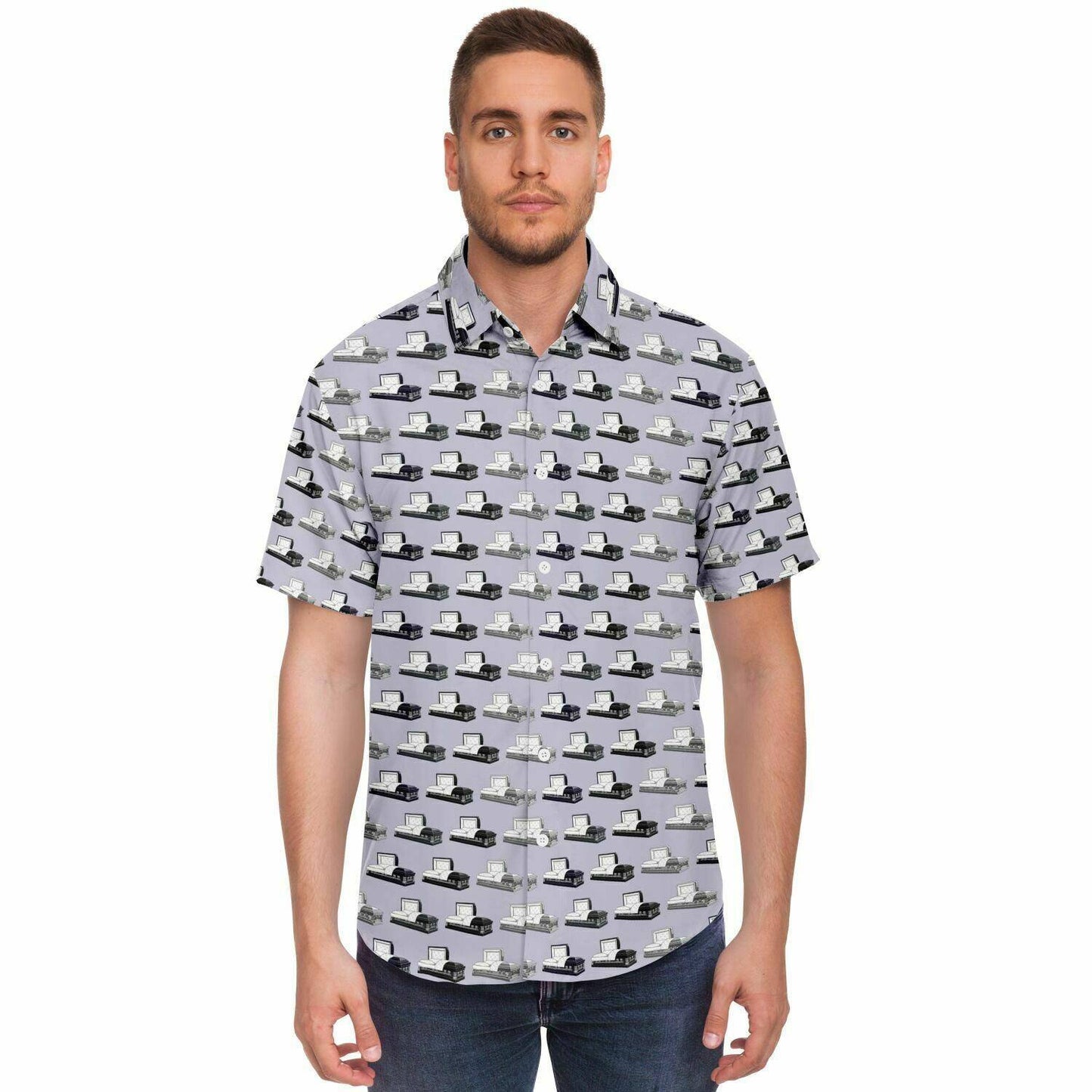 Man wearing light purple button up tee shirt with dark grey, silver, and dark purple steel coffins or open casket pattern. Front view.