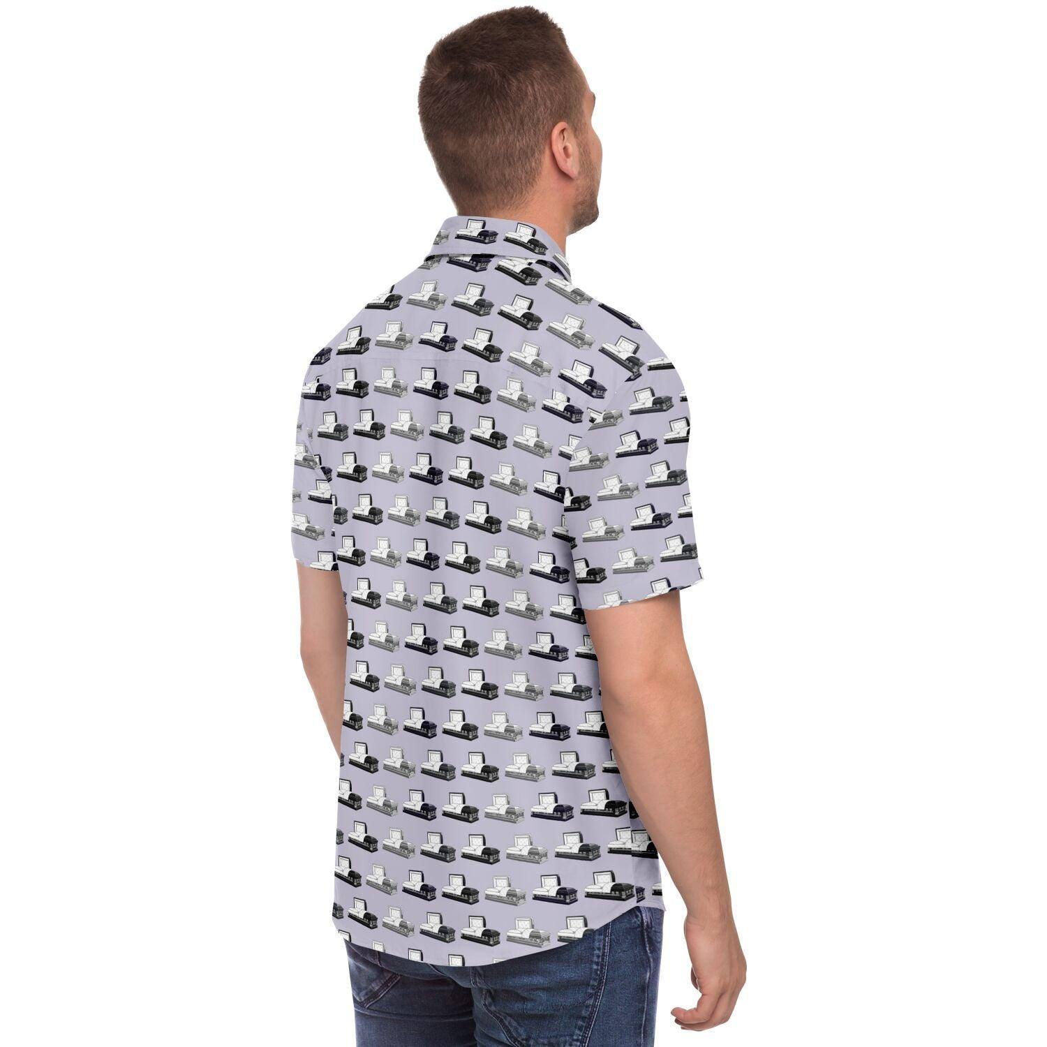 Side angle back view of short sleeve button up tee in light purple with silver, dark grey and purple, coffins and caskets pattern