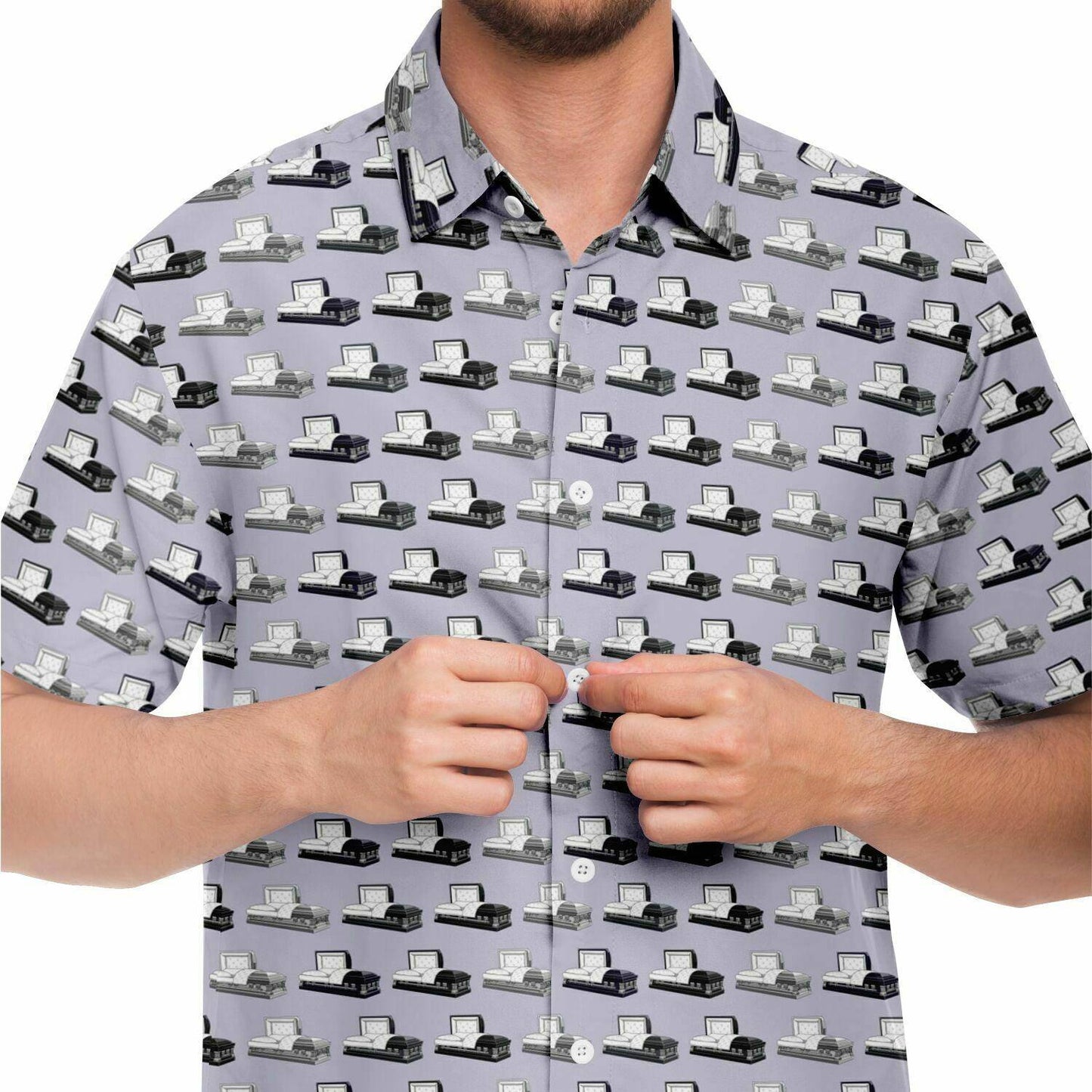 close up front view light purple button up tshirt with dark grey, purple, and silver coffin and casket pattern