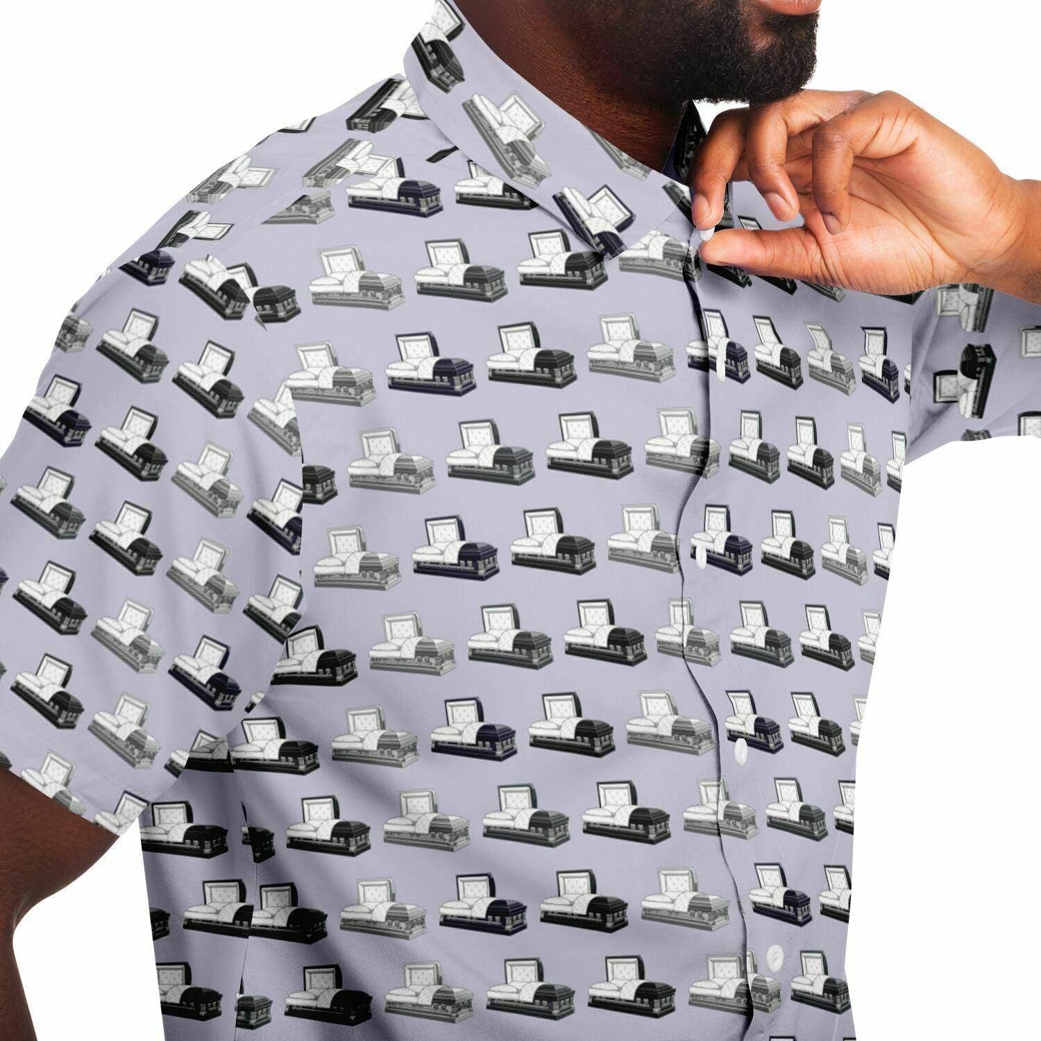 close up side view light purple button down tee shirt with dark grey, purple, silver casket and coffin pattern