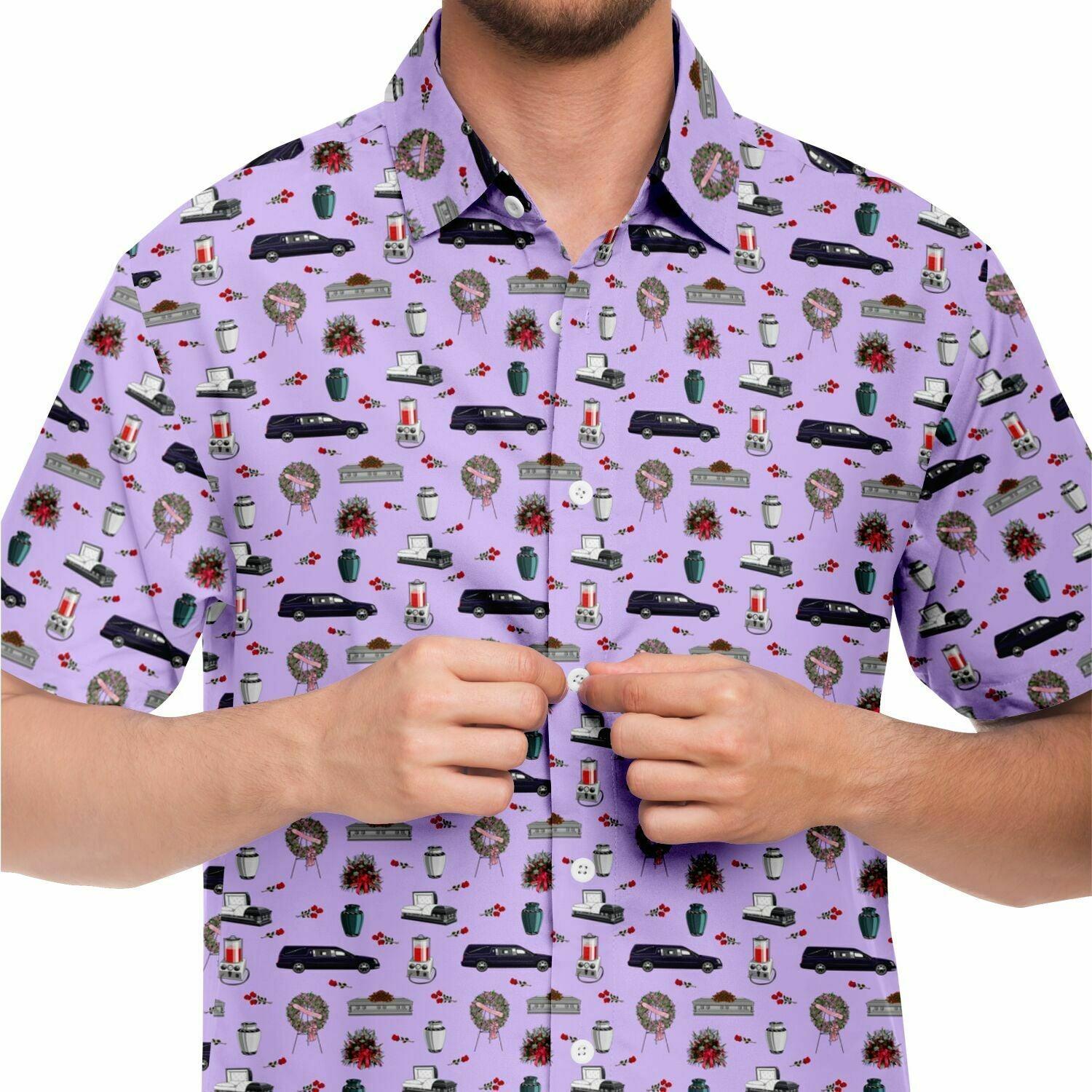 close up front view. Light purple violet button up short sleeve shirt with funeral hearse, coffin, casket, urn, embalming machine pattern