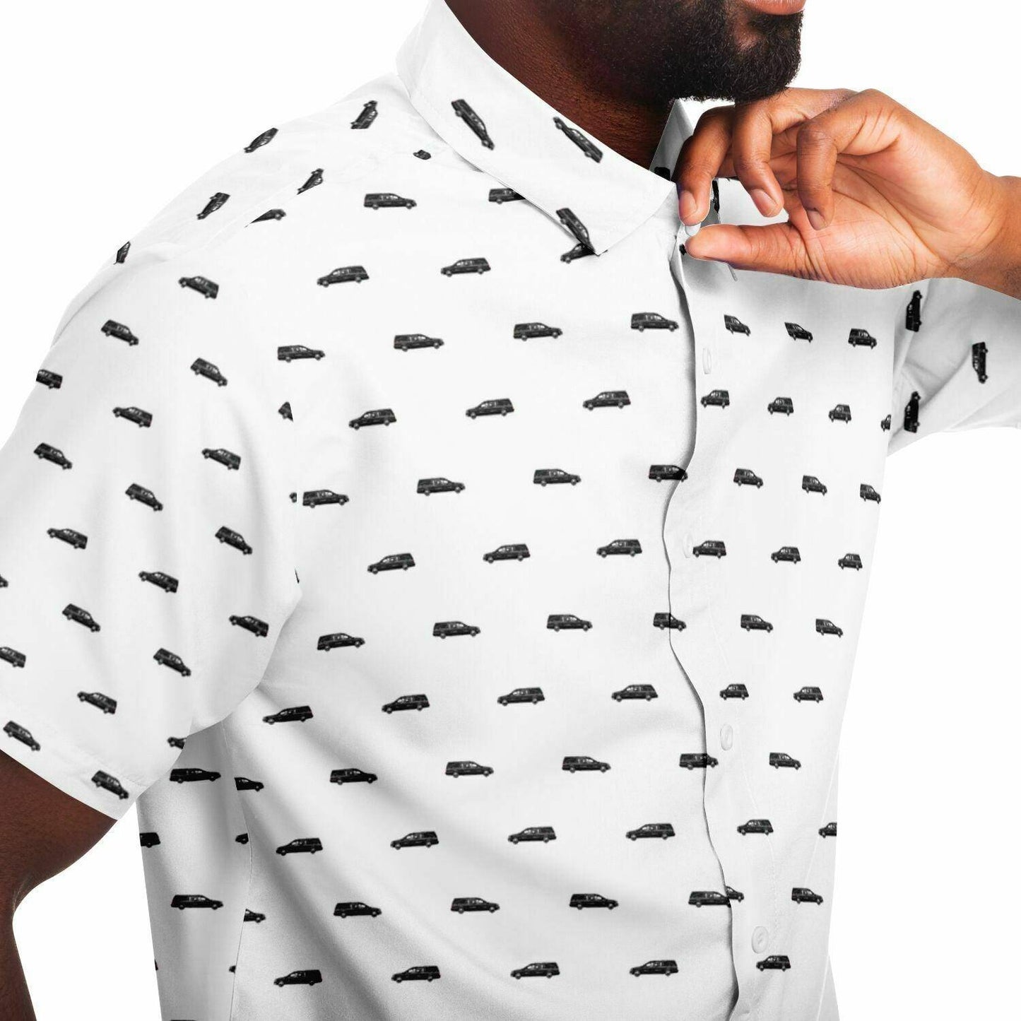 Close up view of man wearing a white button up tshirt with a black hearse pattern