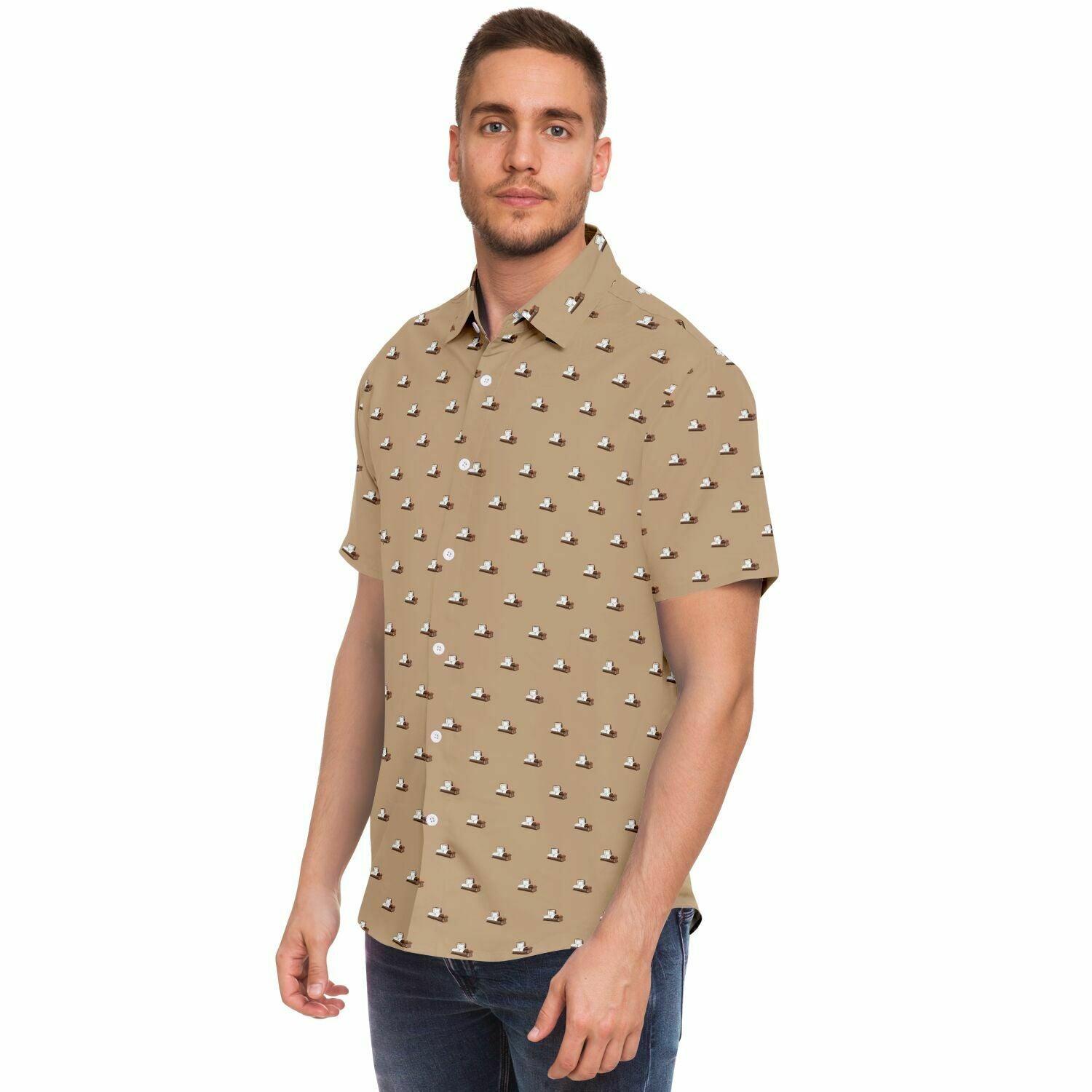 Side angle view of a man wearing a light brown button up short sleeve tshirt with a dark brown coffin pattern. They are modern steel open caskets