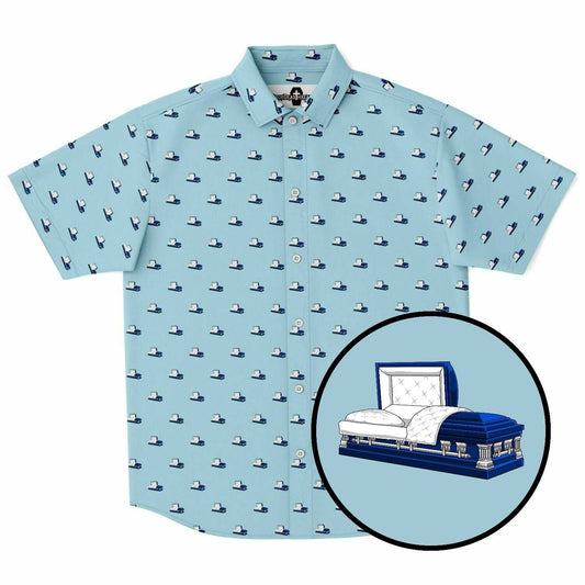 Light blue button up short sleeve shirt featuring a dark blue coffin pattern. It is an open casket on this button down tee. Front view