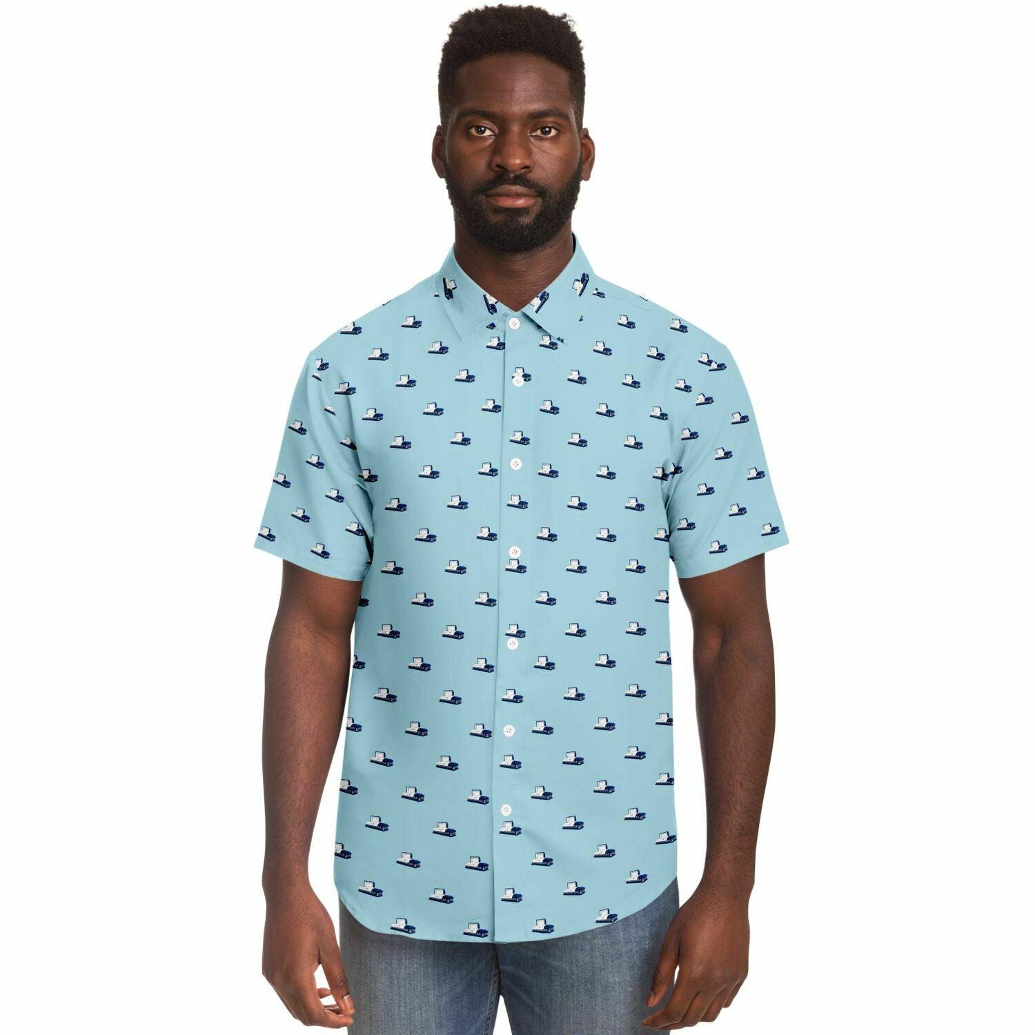 Male model wearing a light blue button down or button up short sleeve shirt with a coffin pattern featuring dark blue open caskets. Frontal view.