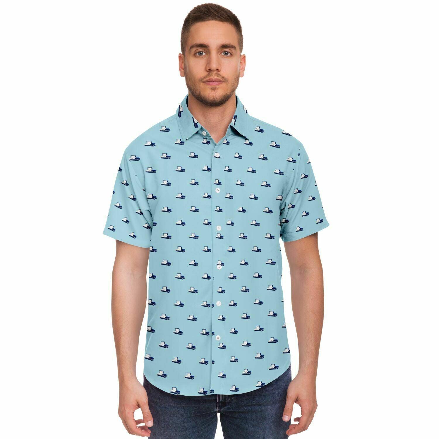 Man wearing a button down short sleeve tee. This button up shirt has a dark blue coffin pattern. Front view.