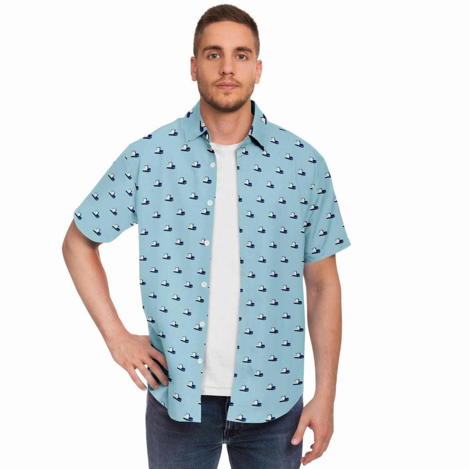 Man wearing a button up tshirt, opened, with little blue caskets on it. The coffins in this pattern are dark blue, metal, and open. 