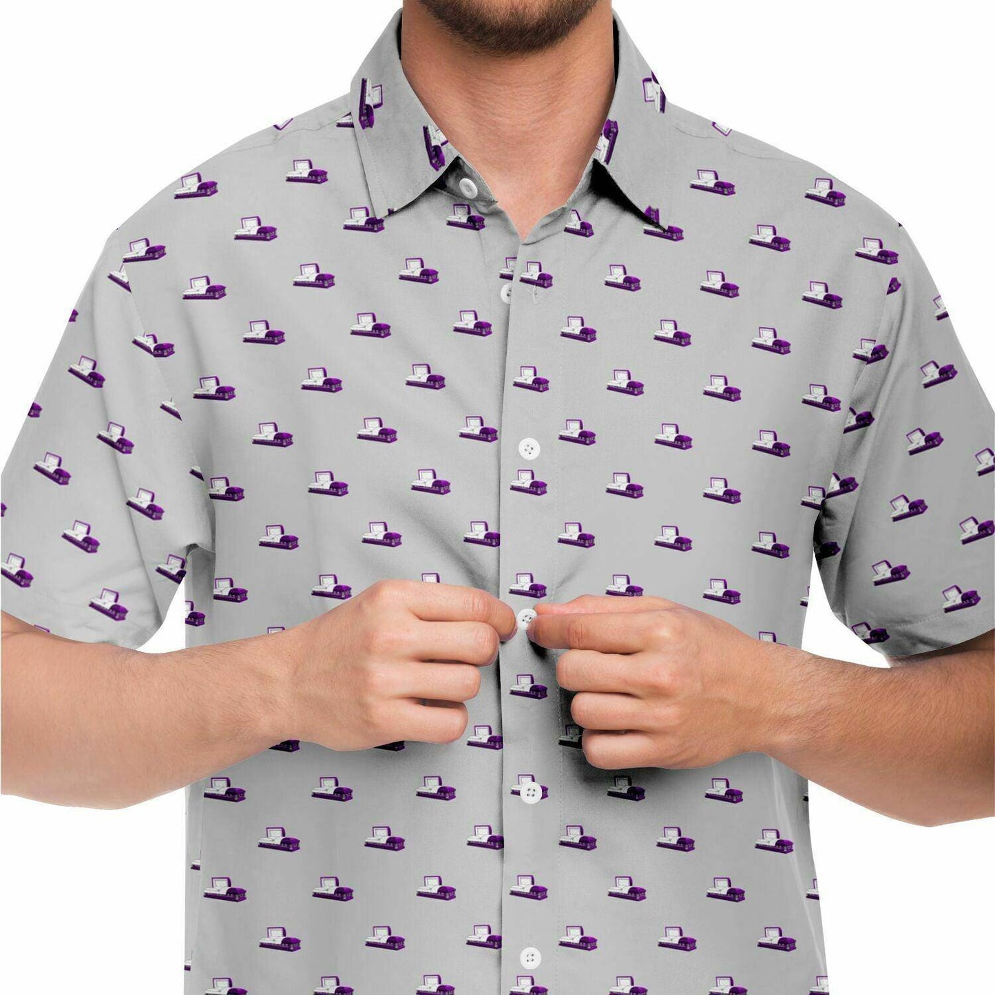 light grey button up short sleeve shirt with purple coffin or open casket pattern. close up front view