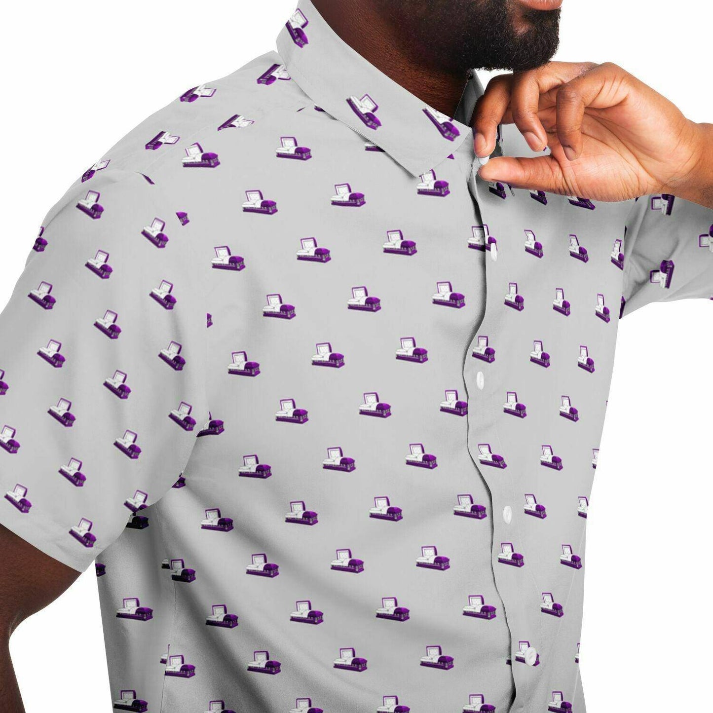 light grey button up button down short sleeve tee featuring purple coffin or open casket pattern. close up side angle view