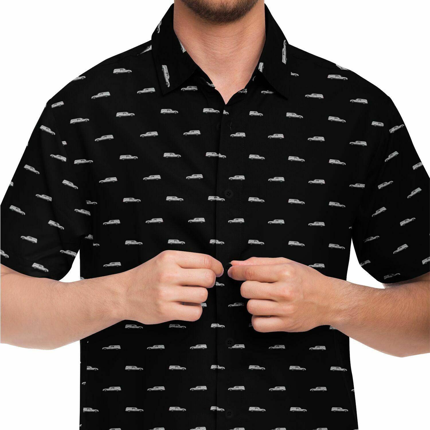 Man wearing black button up tshirt with silver hearse funeral coach pattern. Front view