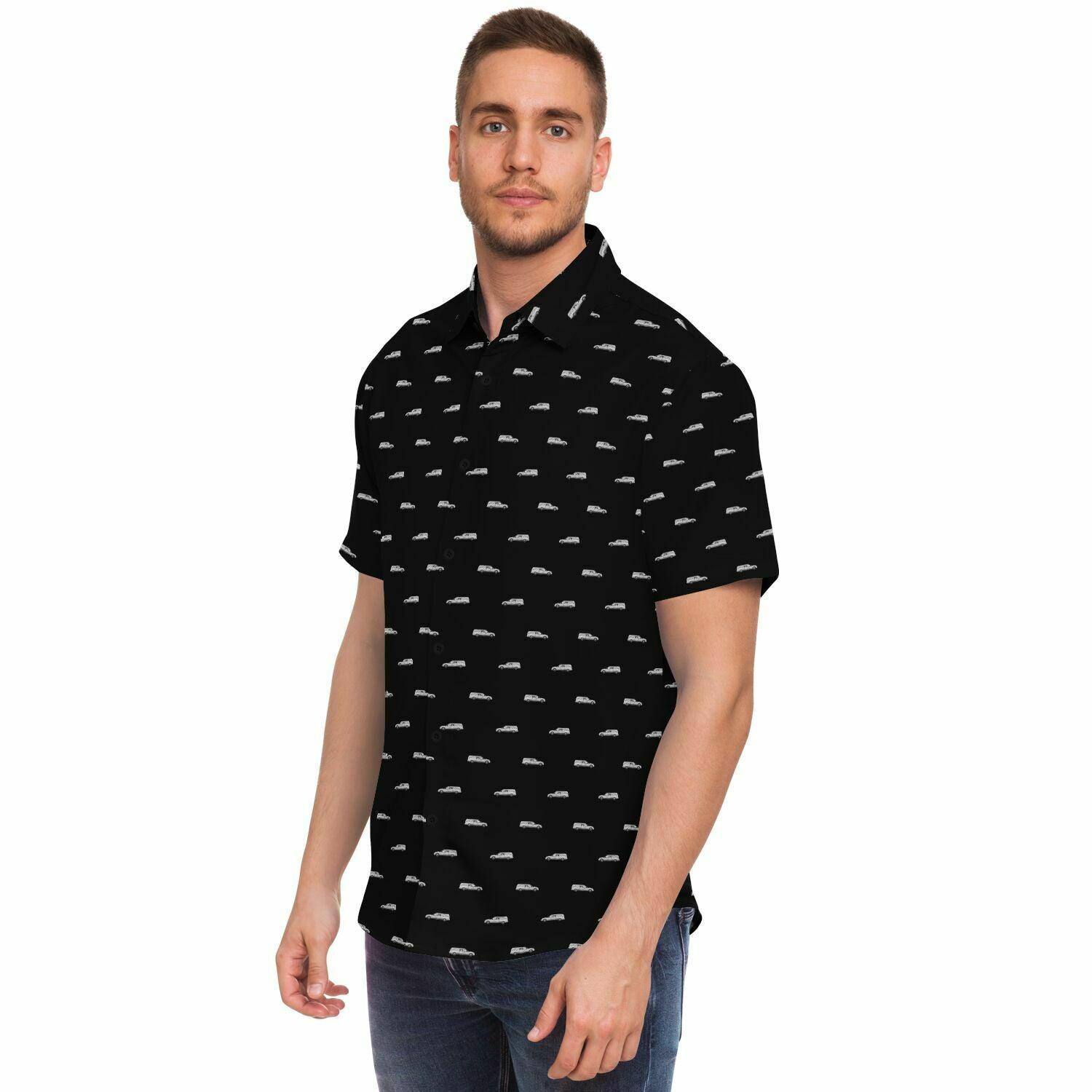 Man wearing black button down button up tee with silver funeral hearse pattern. Side angled view