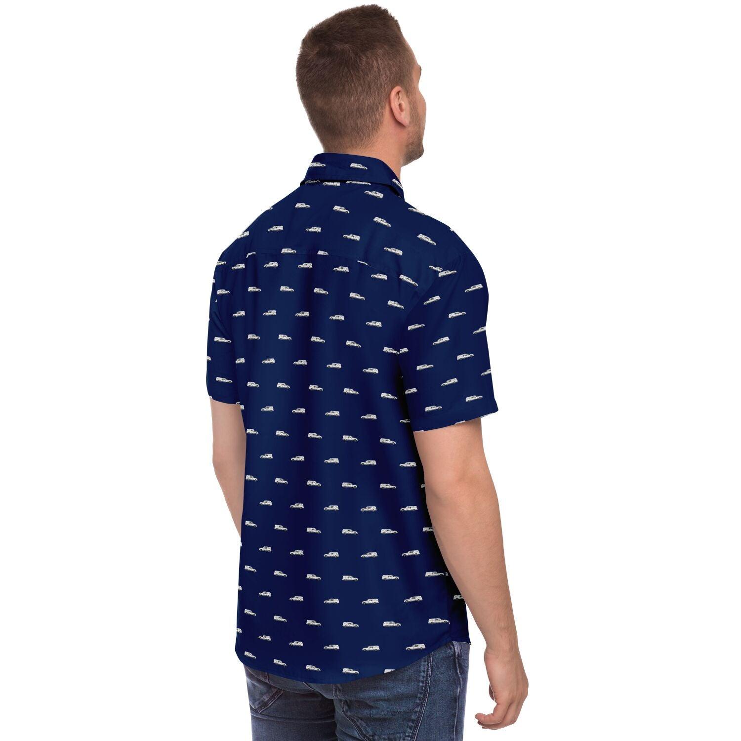 man wearing a short sleeve navy blue button down shirt with a white hearse pattern. Back side angle view