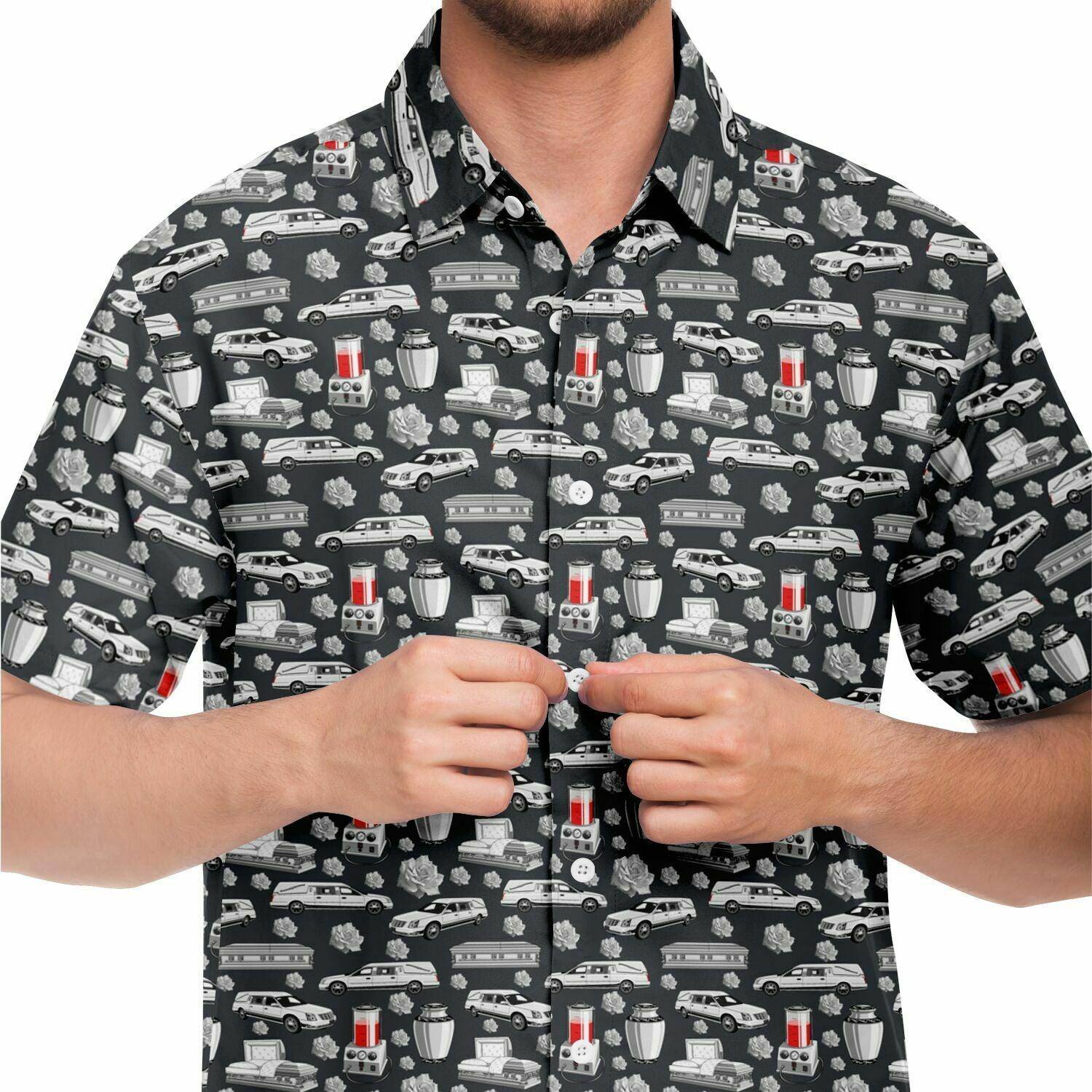 close up view dark grey button up shirt with white pattern of hearse, coffin, casket, cremation urn, rose, embalming machine